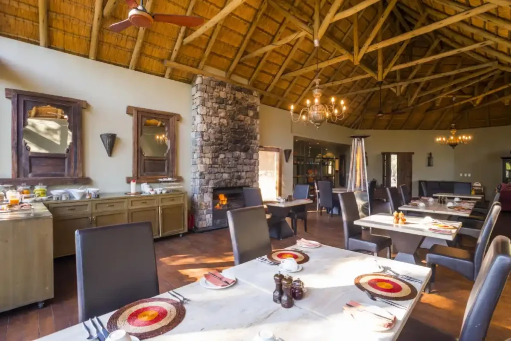 Breakfast buffet and table setting in the dining room with a fire in the fireplace.