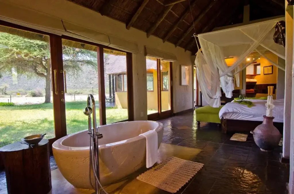 Thatched suite with a free-standing bath and a king-size bed with bushveld views.