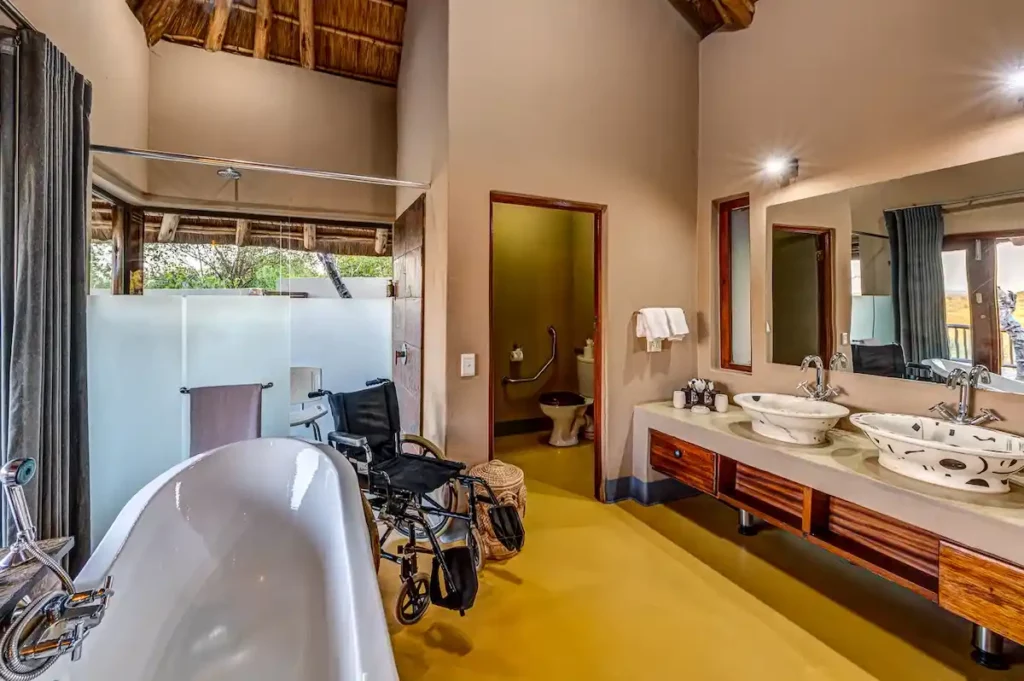 En-suite bathroom- suitable for the mobility impaired- with shower, bathtub, dual vanities and toilet.