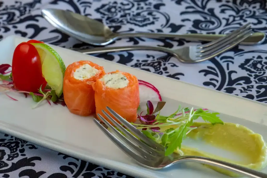 Stylish image of sushi and brightly coloured trimmings elegantly displayed on a platter.