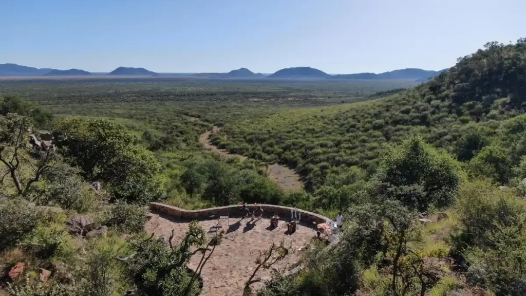 Aerial image of "The Cliff" viewing point with views of the bushveld and distant mountains.