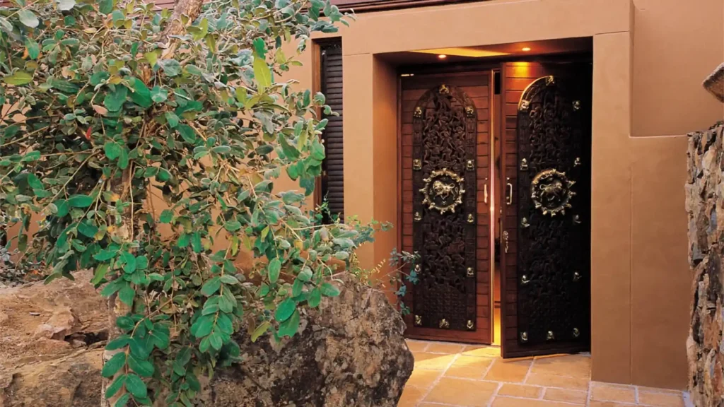 Ornate carved double doors with lion handles at lodge entrance